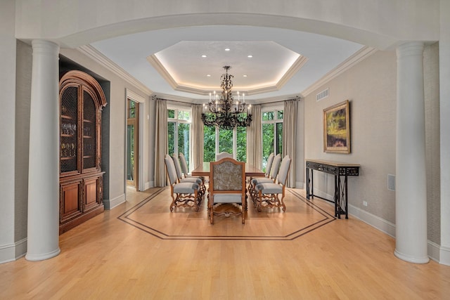 8698 S Madison St, Burr Ridge, IL 60527 - dining room with a chandelier, wood finished floors, a tray ceiling, crown molding, and ornate columns