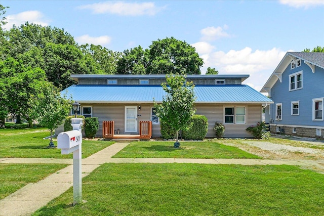 501 N Center St, Colfax, IL 61728 - view of front of home with a metal roof, a front lawn, and a porch