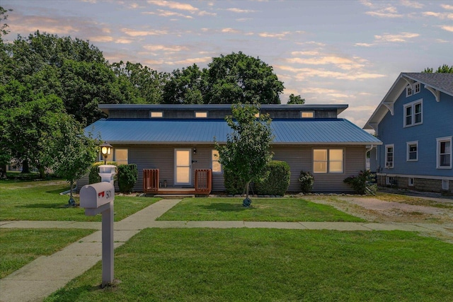 501 N Center St, Colfax, IL 61728 - view of front facade featuring a metal roof and a yard