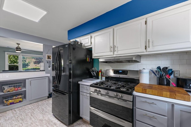 501 N Center St, Colfax, IL 61728 - kitchen featuring gas range, exhaust hood, tasteful backsplash, gray cabinets, and freestanding refrigerator