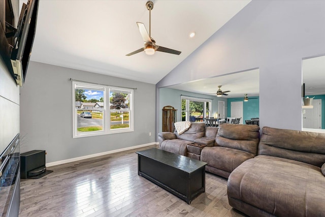 501 N Center St, Colfax, IL 61728 - living room featuring a ceiling fan, light wood-type flooring, and high vaulted ceiling