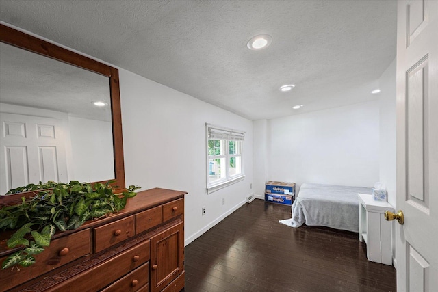 501 N Center St, Colfax, IL 61728 - bedroom featuring dark wood finished floors, a textured ceiling, and recessed lighting