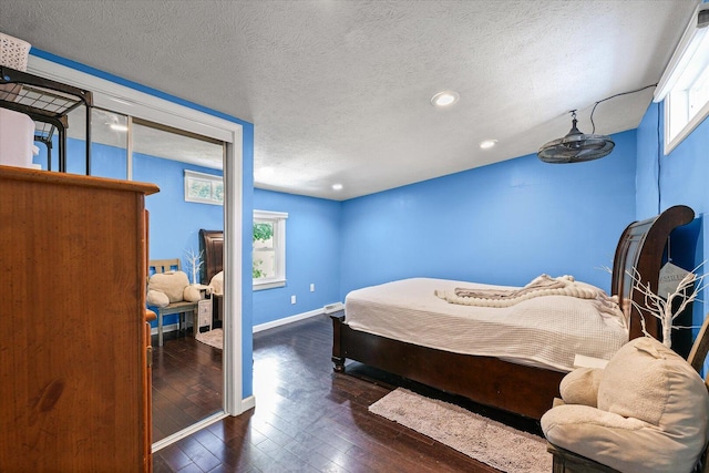 501 N Center St, Colfax, IL 61728 - bedroom with wood-type flooring, a textured ceiling, multiple windows, and recessed lighting