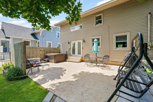 501 N Center St, Colfax, IL 61728 - back of property with a hot tub, french doors, a patio area, and entry steps