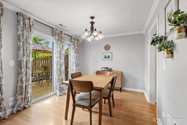 521 Nebraska Cir, Carol Stream, IL 60188 - dining area with ornamental molding, light wood-style flooring, and a chandelier