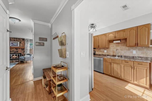 521 Nebraska Cir, Carol Stream, IL 60188 - kitchen with dishwasher, crown molding, light wood-type flooring, tasteful backsplash, and a fireplace