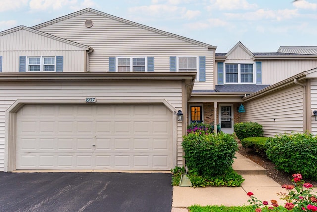 1937 Bayview Ln Unit 0, Aurora, IL 60506 - traditional-style home with asphalt driveway, an attached garage, and board and batten siding