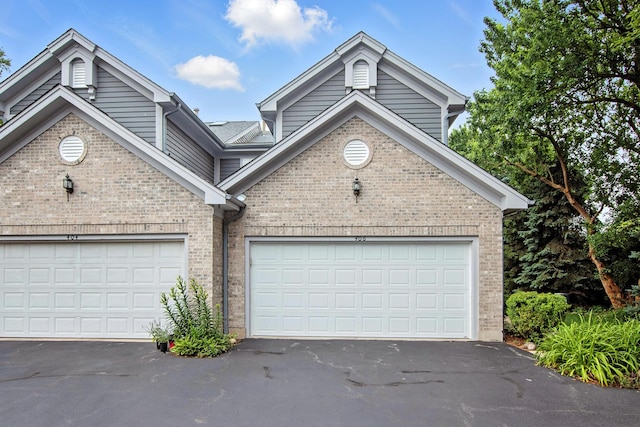 406 Kresswood Dr, Mchenry, IL 60050 - view of front of house featuring brick siding, asphalt driveway, and an attached garage
