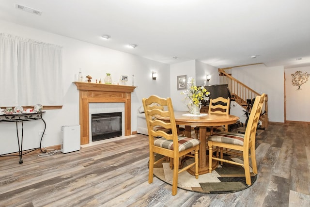 406 Kresswood Dr, Mchenry, IL 60050 - dining area featuring wood finished floors, stairway, and a tile fireplace