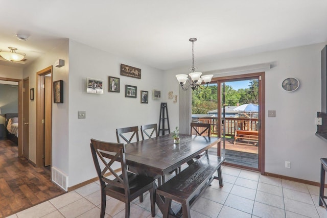 704 W Sheridan Rd, Lakemoor, IL 60051 - dining area featuring light tile patterned flooring and a chandelier