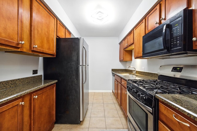 9516 S Kildare Ave Unit 3S, Oak Lawn, IL 60453 - kitchen featuring stainless steel appliances, light tile patterned floors, brown cabinets, and dark stone countertops