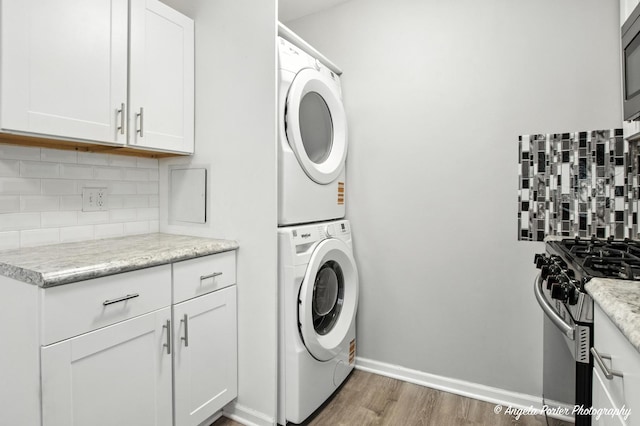 4420 Clearview Dr, Mchenry, IL 60050 - laundry room featuring estacked washer and dryer and wood finished floors