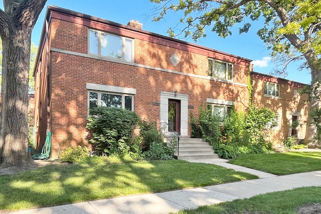 423 Edgewood Pl Unit 2, River Forest, IL 60305 - view of front facade with brick siding, a front lawn, and a chimney