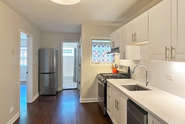 423 Edgewood Pl Unit 2, River Forest, IL 60305 - kitchen with appliances with stainless steel finishes, under cabinet range hood, dark wood-style flooring, and white cabinetry