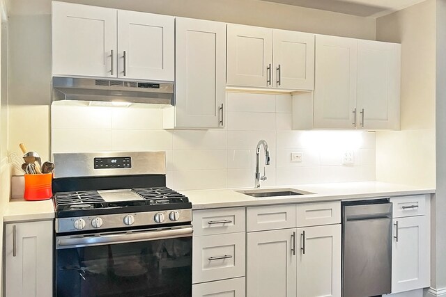 423 Edgewood Pl Unit 2, River Forest, IL 60305 - kitchen with stainless steel gas range oven, under cabinet range hood, tasteful backsplash, and white cabinets