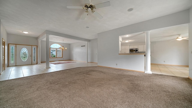 1126 Ingram Rd, Rockford, IL 61108 - unfurnished living room featuring ceiling fan, light tile patterned floors, decorative columns, light colored carpet, and a chandelier