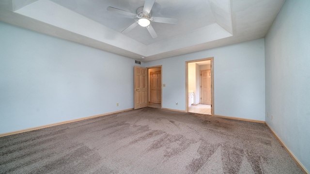 1126 Ingram Rd, Rockford, IL 61108 - unfurnished bedroom featuring carpet flooring, a raised ceiling, and a ceiling fan