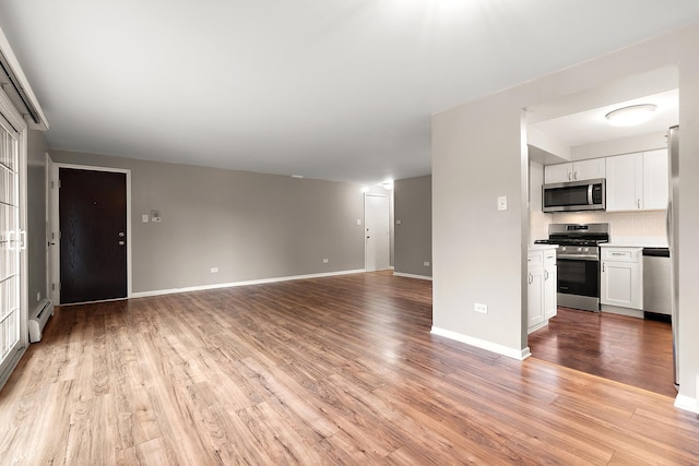 9815 Nottingham Ave Unit 201, Chicago Ridge, IL 60415 - unfurnished living room with light wood-style floors and a baseboard radiator