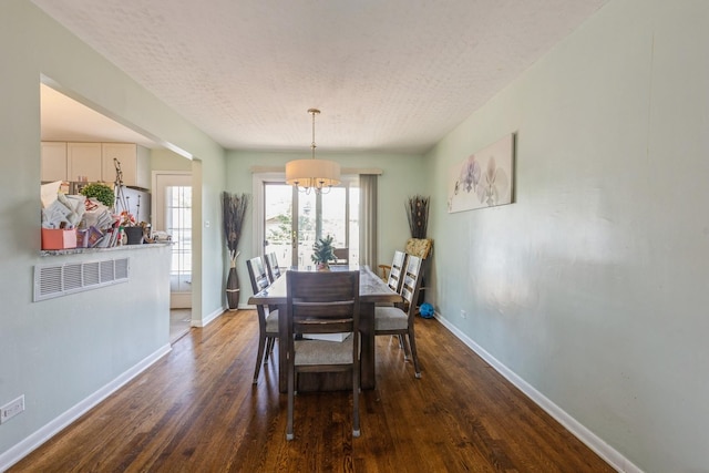 14772 Menard Ave, Oak Forest, IL 60452 - dining room featuring dark wood finished floors, a chandelier, and a textured ceiling