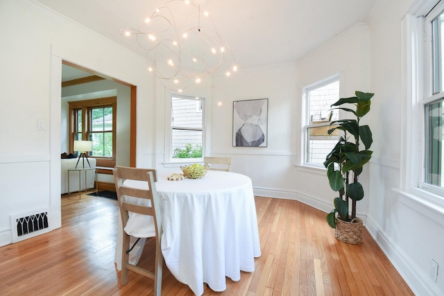 125 S Ridgeland Ave, Oak Park, IL 60302 - dining area featuring crown molding, a chandelier, plenty of natural light, and light wood-style flooring