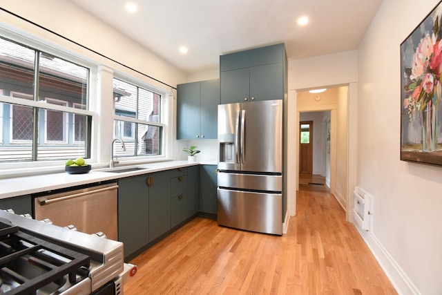 125 S Ridgeland Ave, Oak Park, IL 60302 - kitchen featuring stainless steel appliances, light wood-type flooring, healthy amount of natural light, light countertops, and recessed lighting
