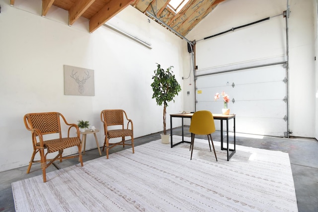 125 S Ridgeland Ave, Oak Park, IL 60302 - sitting room featuring concrete floors, a garage, a high ceiling, and an office area