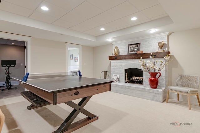 525 Meadow Ln, Libertyville, IL 60048 - rec room with carpet floors, a brick fireplace, a tray ceiling, and recessed lighting