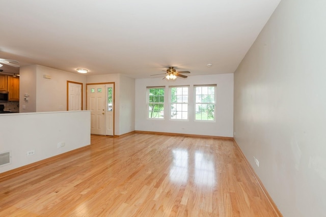 28 Primrose Ln, Oswego, IL 60543 - unfurnished living room with a ceiling fan and light wood-type flooring
