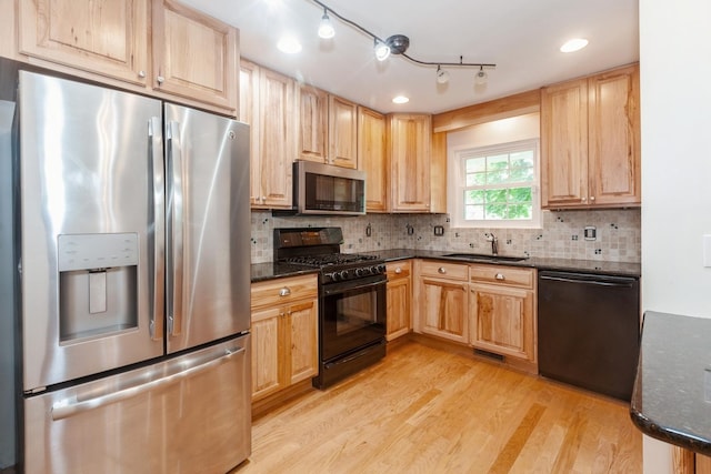 28 Primrose Ln, Oswego, IL 60543 - kitchen featuring black appliances, light brown cabinets, light wood-style flooring, dark stone countertops, and recessed lighting