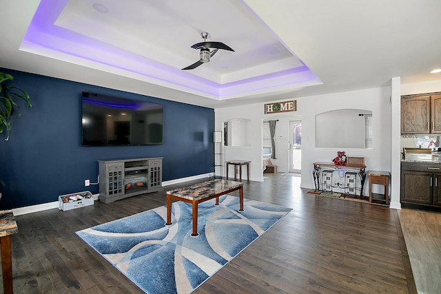 1867 Robert Dr, Bourbonnais, IL 60914 - living room with a tray ceiling, ceiling fan, arched walkways, and wood finished floors