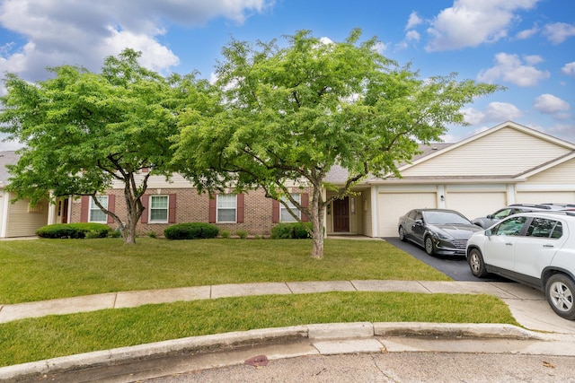 1028 Wynnfield Ct Unit C, Elgin, IL 60120 - view of front of home with a garage, driveway, a front yard, and brick siding