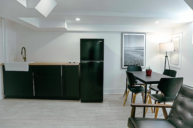 2913 N Kolmar Ave, Chicago, IL 60641 - kitchen featuring freestanding refrigerator, dark cabinetry, recessed lighting, light countertops, and light wood-style flooring