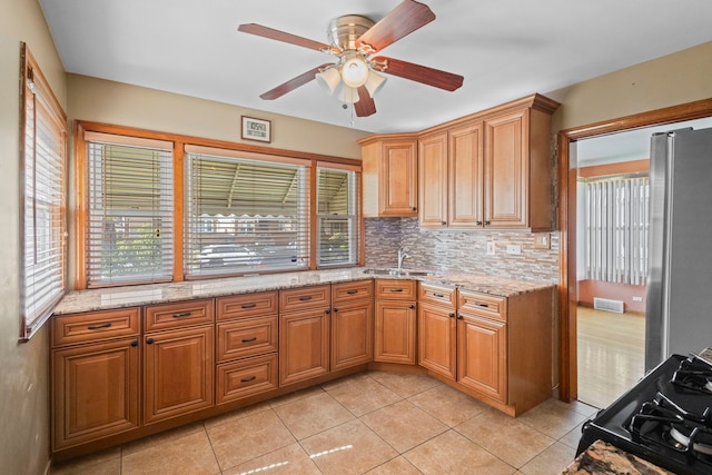 5144 W Saint Paul Ave, Chicago, IL 60639 - kitchen with backsplash, a ceiling fan, stainless steel refrigerator, and healthy amount of natural light