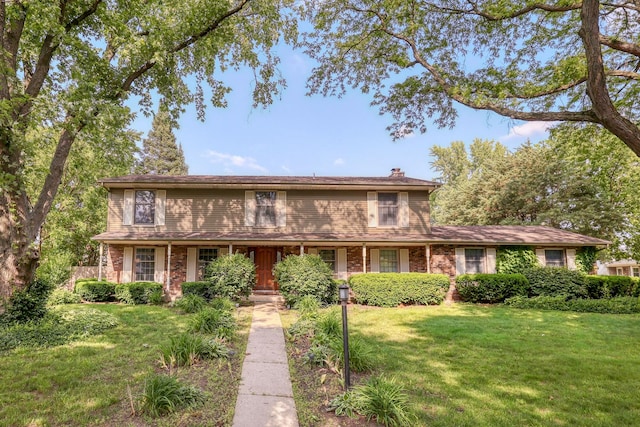 6S503 Bridlespur Dr, Naperville, IL 60540 - traditional-style home with a front yard, a chimney, and brick siding