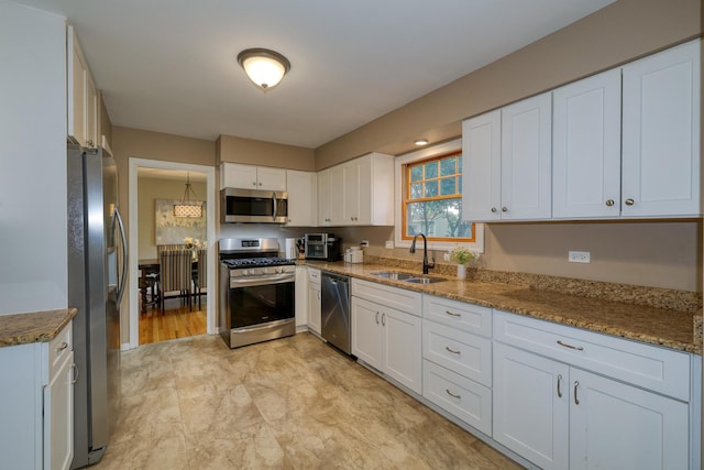 6S503 Bridlespur Dr, Naperville, IL 60540 - kitchen featuring stainless steel appliances, white cabinetry, light stone countertops, and radiator