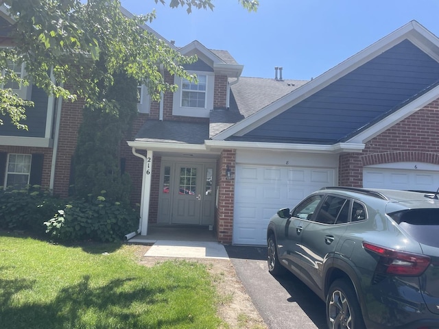 216 Charleston Ct Unit 8, Schaumburg, IL 60193 - view of front facade with brick siding, a garage, roof with shingles, and asphalt driveway