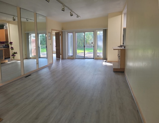 864 Sumac Rd, Highland Park, IL 60035 - unfurnished living room with rail lighting, wood finished floors, and plenty of natural light