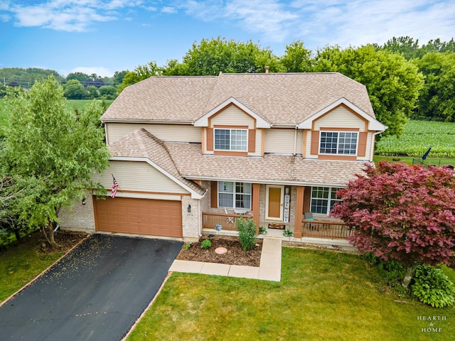 2019 Olde Mill Ln, Mchenry, IL 60050 - traditional home featuring a porch, asphalt driveway, a front yard, a garage, and a shingled roof