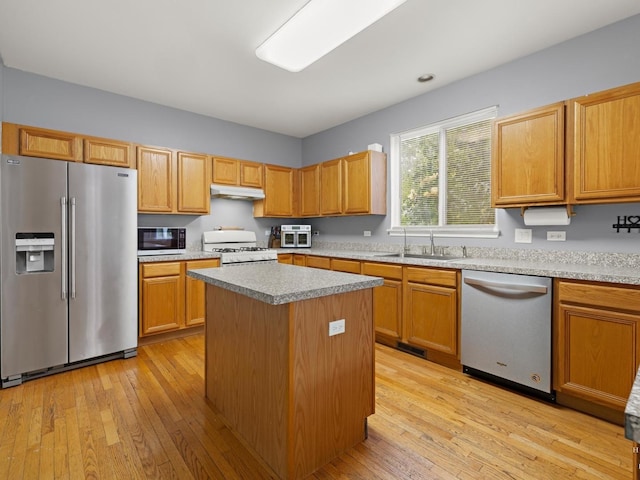 2019 Olde Mill Ln, Mchenry, IL 60050 - kitchen with stainless steel appliances, light wood-style flooring, a kitchen island, and under cabinet range hood