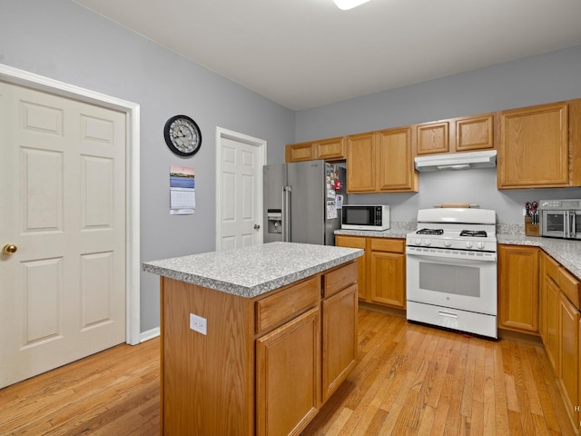 2019 Olde Mill Ln, Mchenry, IL 60050 - kitchen with white appliances, under cabinet range hood, light wood-type flooring, and light countertops