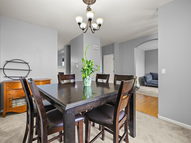 2019 Olde Mill Ln, Mchenry, IL 60050 - dining space featuring arched walkways, light colored carpet, and a chandelier