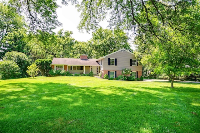 560 Golf Ln, Lake Forest, IL 60045 - split level home with a chimney, a front yard, and brick siding