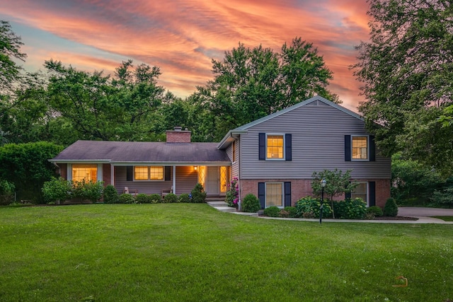 560 Golf Ln, Lake Forest, IL 60045 - tri-level home featuring a front lawn, a chimney, brick siding, and a porch