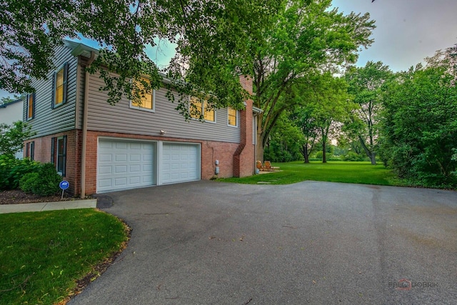 560 Golf Ln, Lake Forest, IL 60045 - view of home's exterior with asphalt driveway, a garage, brick siding, and a lawn
