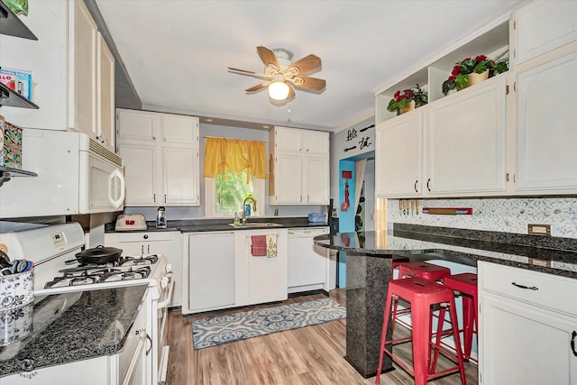 10730 S Ridgeland St, Worth, IL 60482 - kitchen featuring white appliances, white cabinets, a ceiling fan, light wood-style flooring, and dark stone counters