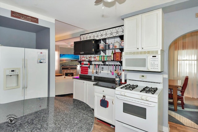 10730 S Ridgeland St, Worth, IL 60482 - kitchen with white appliances, a ceiling fan, wood finished floors, arched walkways, and tasteful backsplash