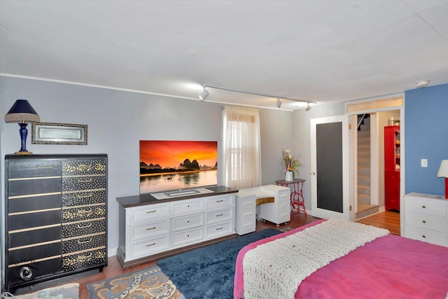 10730 S Ridgeland St, Worth, IL 60482 - bedroom featuring rail lighting and dark wood-type flooring