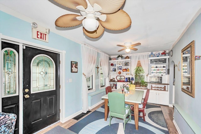10730 S Ridgeland St, Worth, IL 60482 - dining space featuring ceiling fan, wood finished floors, and ornamental molding