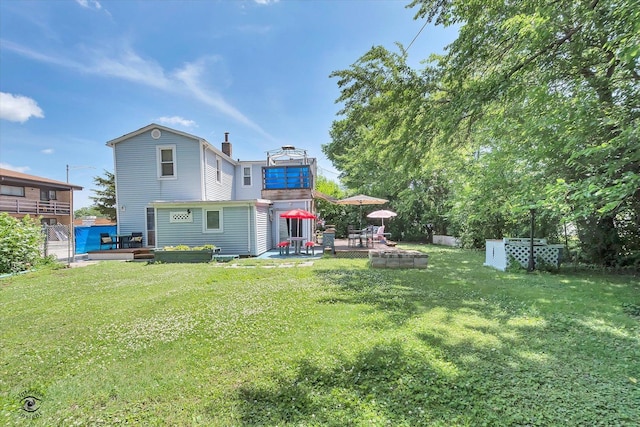 10730 S Ridgeland St, Worth, IL 60482 - rear view of house featuring a deck, a chimney, and a patio area