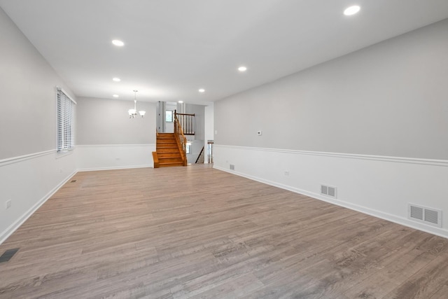 12123 S 72nd Ct, Palos Heights, IL 60463 - empty room featuring a chandelier, recessed lighting, stairs, and light wood-style flooring